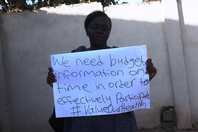 woman holding #ValueOurHealth sign 
